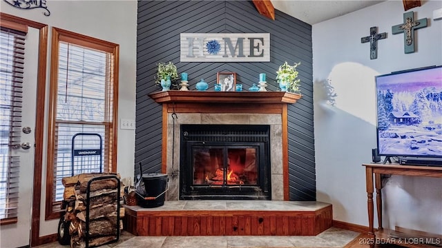 living room with a wealth of natural light, a fireplace, and baseboards