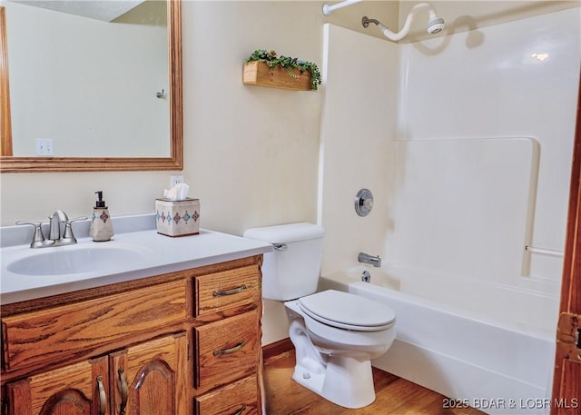 full bathroom featuring wood-type flooring, bathtub / shower combination, vanity, and toilet