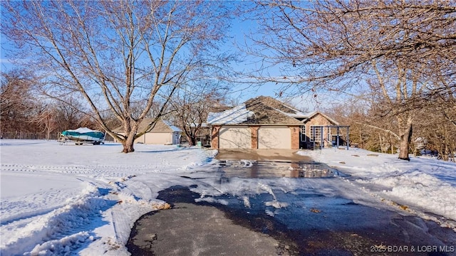 yard layered in snow with a garage