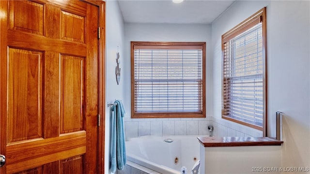 bathroom with a relaxing tiled tub