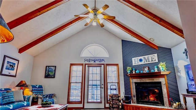 living room with beam ceiling, a tile fireplace, high vaulted ceiling, and a ceiling fan