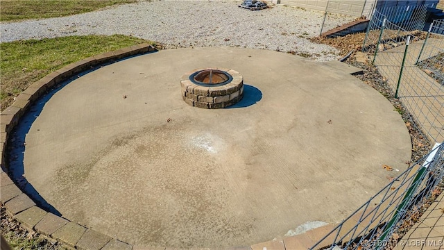 exterior details featuring fence and an outdoor fire pit