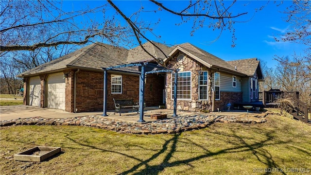 single story home with stone siding, a patio, brick siding, and an outdoor fire pit