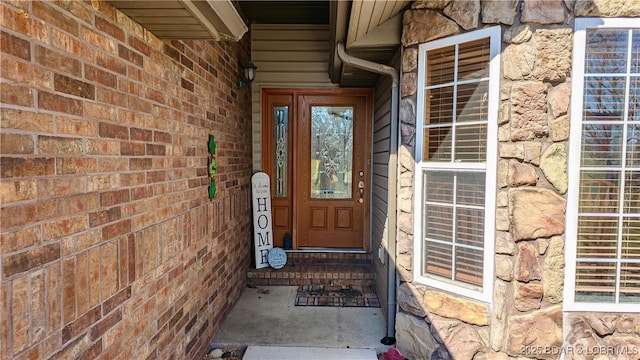 doorway to property with brick siding