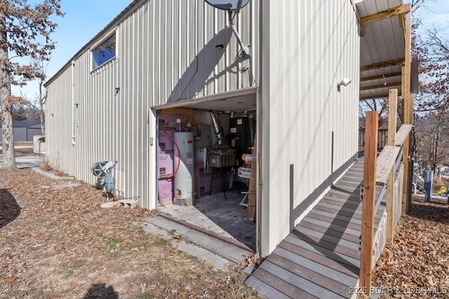 view of property exterior featuring electric panel and water heater