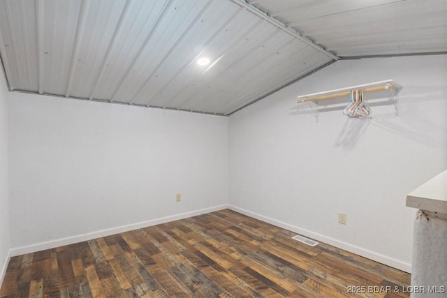 interior space with lofted ceiling and dark wood-type flooring