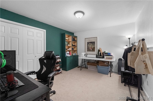 home office with carpet flooring and a textured ceiling