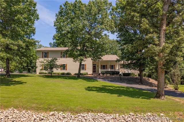 split level home featuring a porch and a front yard