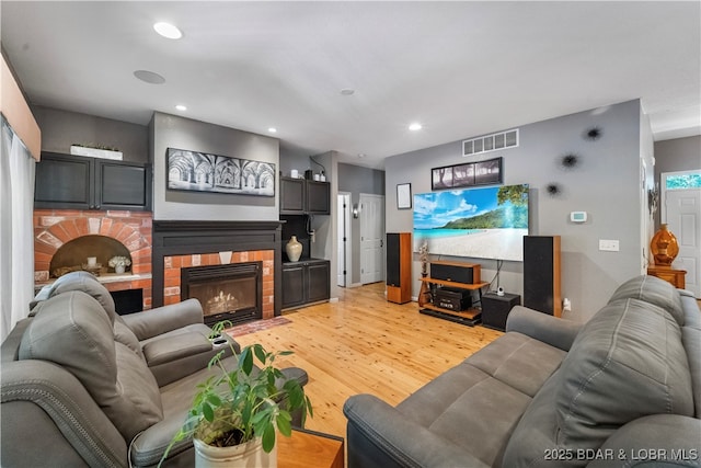 living room with a fireplace and light hardwood / wood-style floors