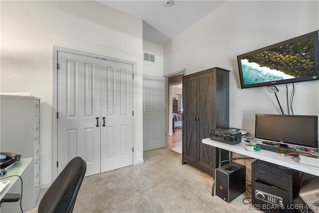 office area featuring lofted ceiling and light carpet