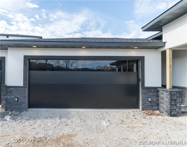 garage with gravel driveway