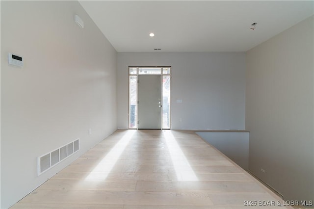 unfurnished room with light wood-type flooring