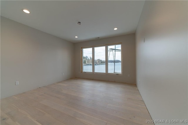 unfurnished room featuring recessed lighting and light wood-style floors