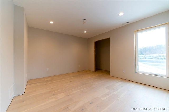 spare room with light wood-type flooring