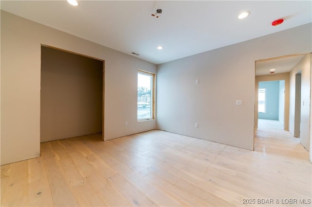 spare room featuring light hardwood / wood-style flooring