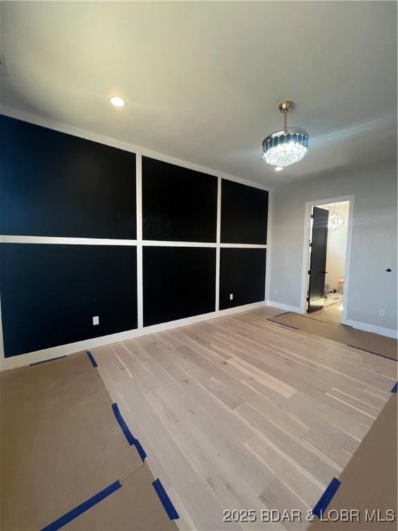 empty room featuring light wood-style flooring and baseboards