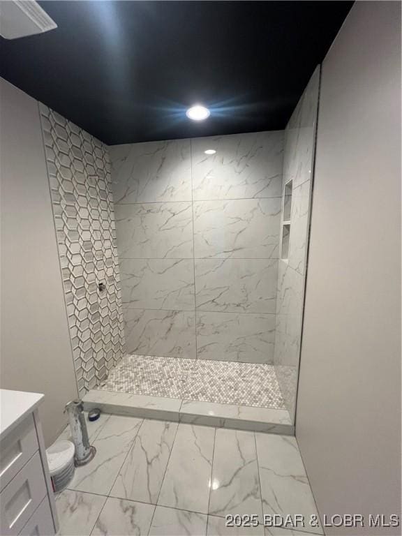 bathroom featuring vanity, a tile shower, recessed lighting, toilet, and marble finish floor