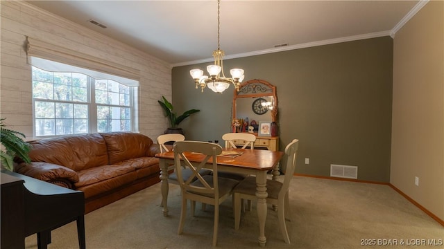 dining room featuring ornamental molding, light carpet, and a notable chandelier