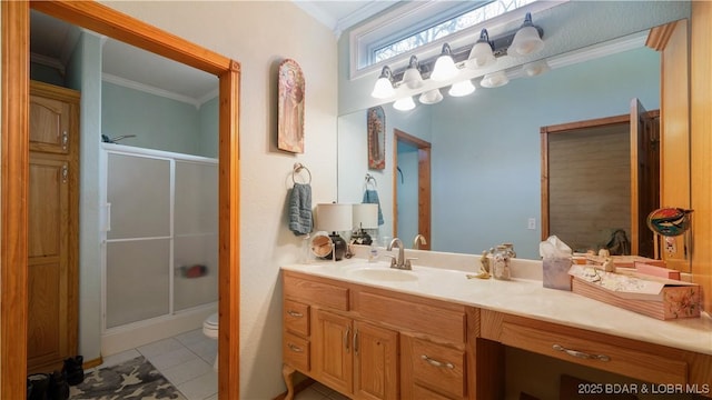 bathroom featuring a shower with door, ornamental molding, tile patterned floors, and vanity