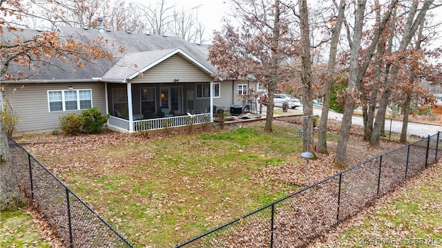 back of house featuring a yard and a sunroom