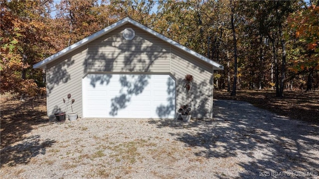 view of property exterior with a garage and an outdoor structure