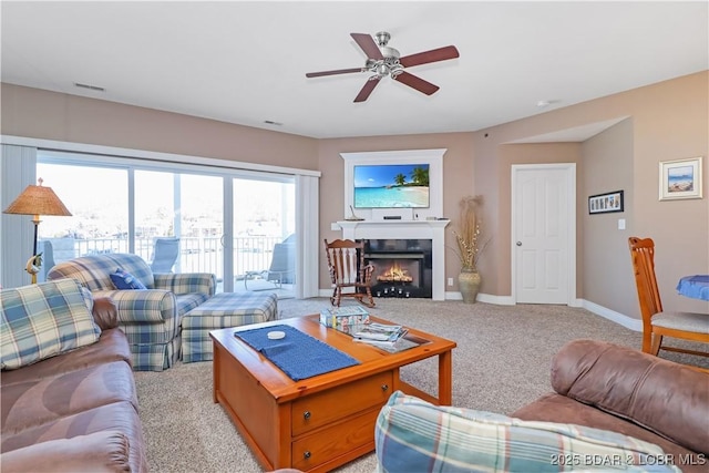 carpeted living room featuring ceiling fan