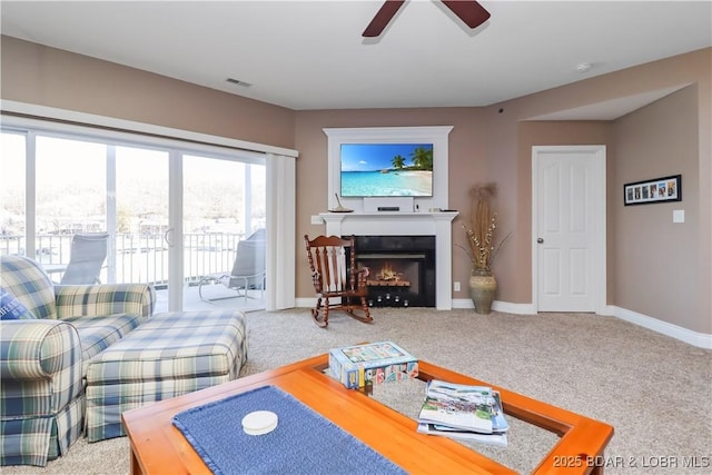 carpeted living room featuring ceiling fan