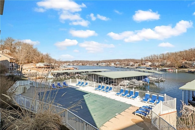 exterior space featuring a community pool, a patio area, and a water view