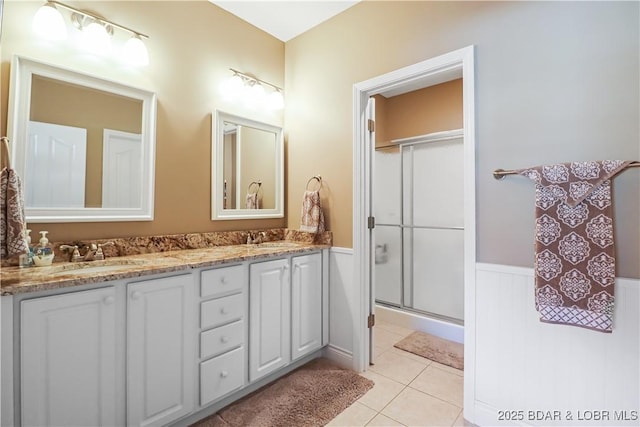 bathroom featuring vanity, an enclosed shower, and tile patterned flooring