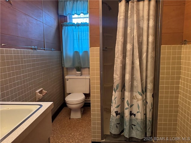 bathroom featuring tile walls, a shower with curtain, and toilet