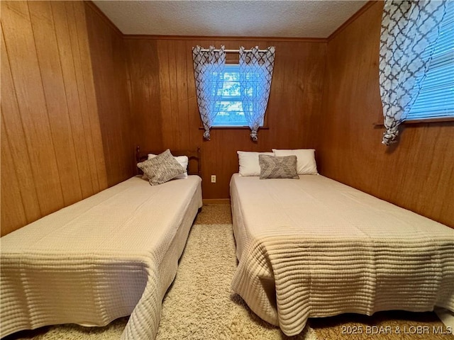 carpeted bedroom featuring a textured ceiling and wood walls