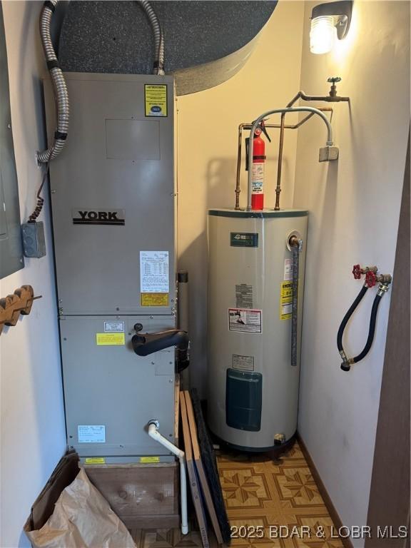 utility room featuring electric water heater and heating unit