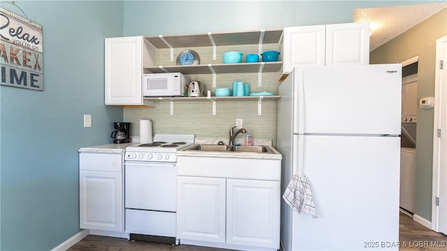 kitchen featuring dark hardwood / wood-style floors, white cabinetry, sink, and white appliances