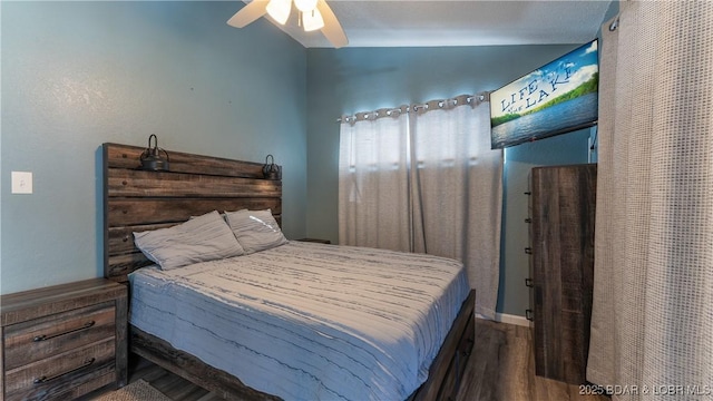 bedroom with ceiling fan and dark hardwood / wood-style floors