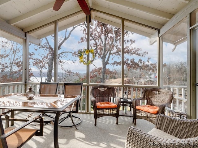 sunroom / solarium with plenty of natural light and lofted ceiling with beams