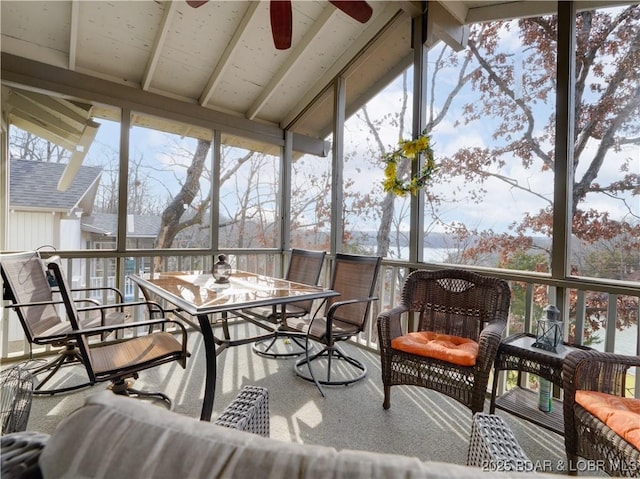 sunroom with vaulted ceiling with beams and ceiling fan