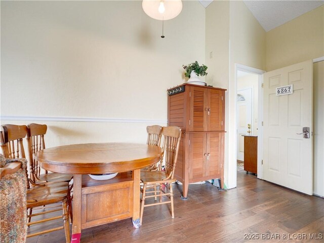 dining space with dark hardwood / wood-style floors