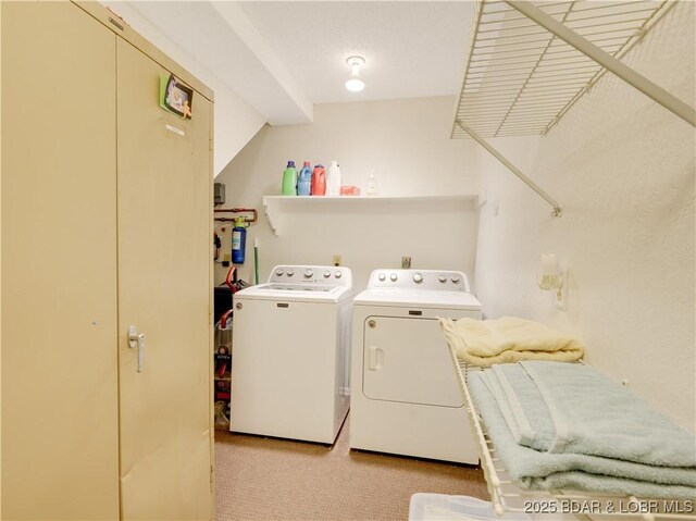 laundry area with light colored carpet and washing machine and clothes dryer