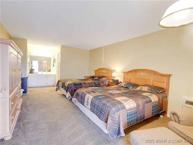 bedroom featuring ensuite bathroom and light colored carpet