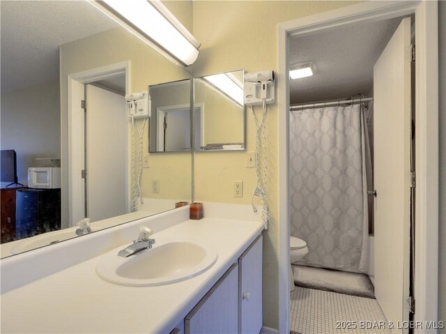 full bathroom with vanity, shower / bath combination with curtain, and toilet