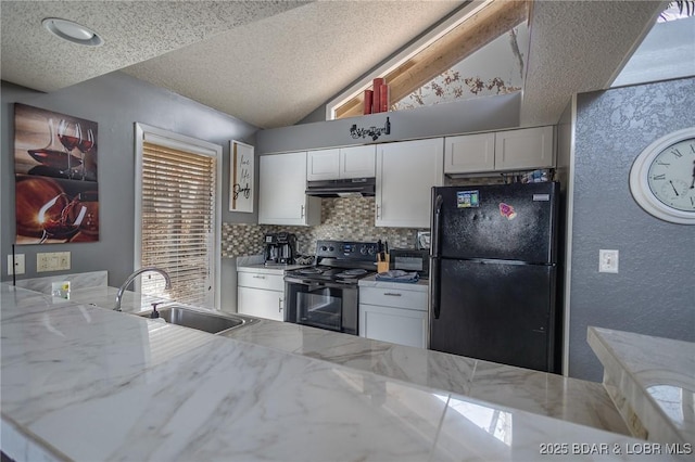 kitchen with vaulted ceiling, white cabinetry, sink, black appliances, and light stone countertops