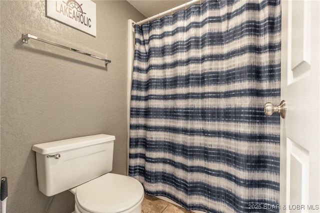 bathroom featuring toilet and a shower with curtain