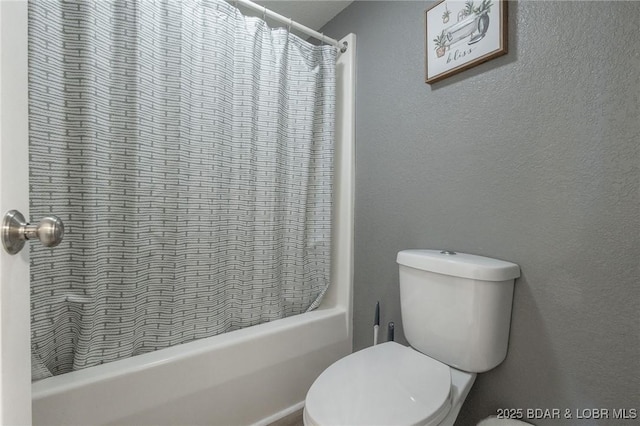 bathroom featuring shower / bath combo and toilet