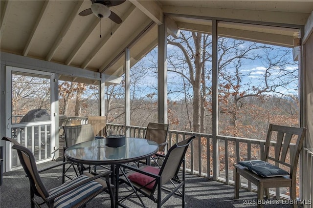 sunroom with lofted ceiling with beams and ceiling fan