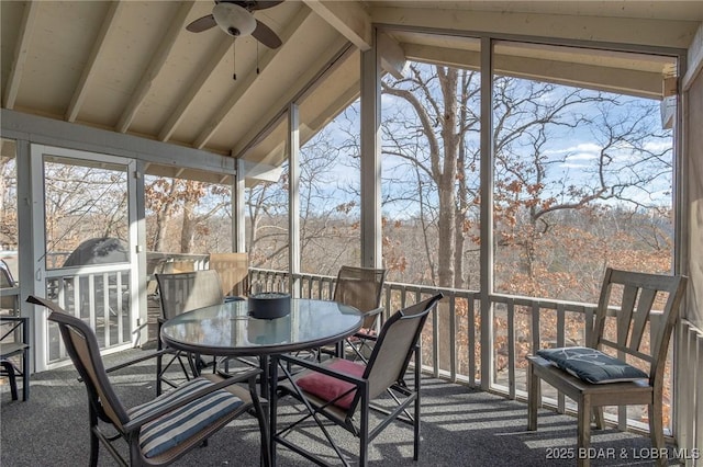 sunroom / solarium with vaulted ceiling with beams, a wealth of natural light, and ceiling fan