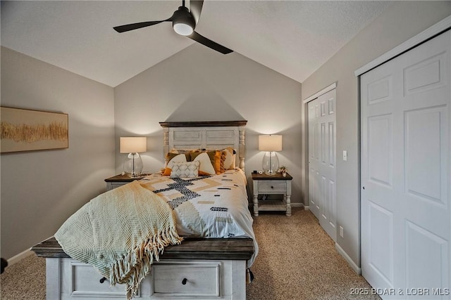 bedroom featuring multiple closets, ceiling fan, vaulted ceiling, and carpet