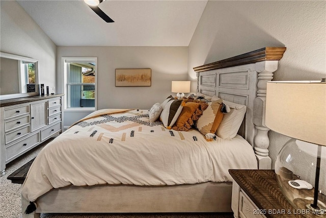 carpeted bedroom featuring ceiling fan and vaulted ceiling