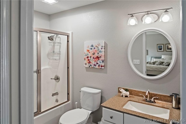 full bathroom featuring enclosed tub / shower combo, vanity, and toilet