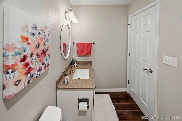 bathroom featuring vanity and toilet