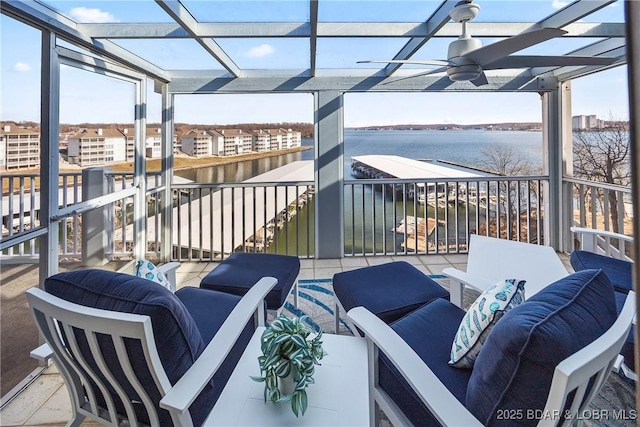 balcony featuring a water view, ceiling fan, and outdoor lounge area